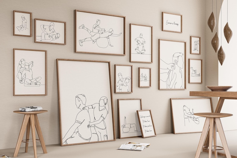 May include: A gallery wall with 13 framed black and white line drawings of people in various poses. The drawings are all in a minimalist style and feature simple lines. The frames are all wooden and have a natural finish. The wall is a light beige color.