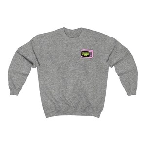 Op de afbeelding: Een set van drie keramische mokken met een gespikkelde, matte afwerking. De mokken zijn in de kleuren cr&egrave;me, lichtgrijs en donkergrijs. Elke mok heeft een eenvoudig, minimalistisch ontwerp en een afgeronde handgreep.