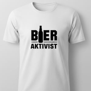 Könnte beinhalten: Weißes T-Shirt mit schwarzem Aufdruck. Der Aufdruck zeigt das Wort "BIER" mit einer Bierflaschen-Silhouette in der Mitte und das Wort "AKTIVIST" darunter. Das T-Shirt hat einen Rundhalsausschnitt und kurze Ärmel.