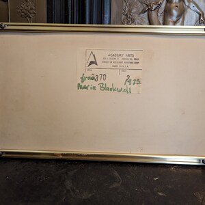 May include: A gold-coloured frame with a white mount and a label that reads "Academy Arts" and "601 N.  Wabash St. Chicago, Ill. 60611" and "Division of Westcraft Industries Corp. Made in U.S.A."  The label also has a handwritten number "680370" and "2475" and the name "Maria Blackwell".