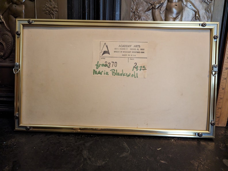 May include: A gold-coloured frame with a white mount and a label that reads "Academy Arts" and "601 N.  Wabash St. Chicago, Ill. 60611" and "Division of Westcraft Industries Corp. Made in U.S.A."  The label also has a handwritten number "680370" and "2475" and the name "Maria Blackwell".