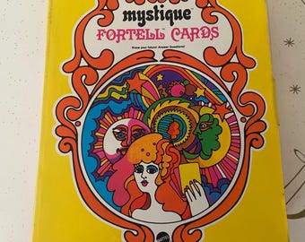 May include: A vintage "Mystique Fortell Cards" box in yellow with orange and white decorative accents. The cover features a colorful illustration of a woman and celestial elements. The box is from 1969 by Mattel.