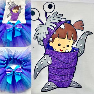 May include: A children's costume set featuring a white t-shirt with a cartoon graphic and a layered tulle skirt. The skirt is a mix of blue and purple with a large blue bow. The graphic is of a child in a purple monster costume.