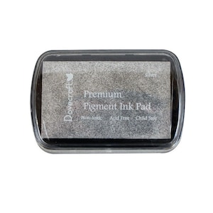 May include: A silver Dovecraft Premium Pigment Ink Pad. The ink pad is non-toxic, acid free, and child safe.