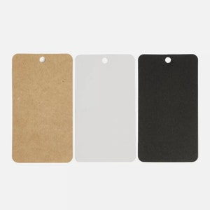 May include: Three rectangular tags in a row, each with a rounded top and a hole for hanging. The tags are brown, white, and black. The tags are blank and ready for customization.
