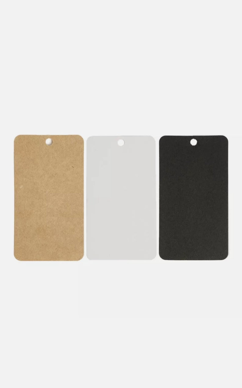 May include: Three rectangular tags in a row, each with a rounded top and a hole for hanging. The tags are brown, white, and black. The tags are blank and ready for customization.