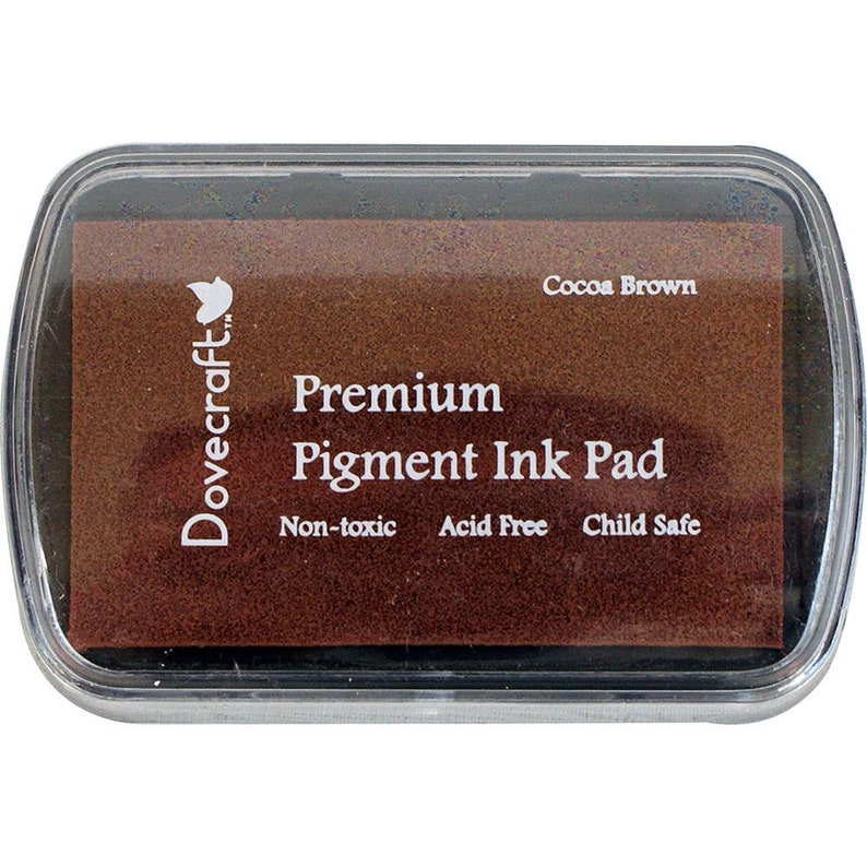 May include: A brown Dovecraft Premium Pigment Ink Pad labeled "Cocoa Brown". The ink pad is non-toxic, acid free, and child safe.
