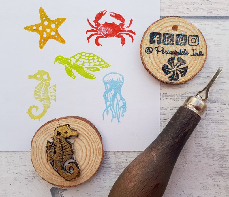 May include: A set of six rubber stamps featuring various sea creatures, including a starfish, crab, turtle, jellyfish, and a seahorse. The stamps are mounted on wooden blocks and are ready to be used for crafting and scrapbooking.