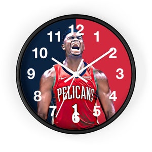 May include: A black and white clock with a red and blue background. The clock face features a basketball player wearing a red jersey with the word "PELICANS" on the front. The player is wearing a white headband and has a determined expression on his face.