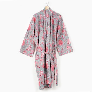 May include: A grey cotton robe with a pink floral print. The robe has a tie belt and long sleeves.