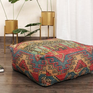 May include: A colorful, patterned floor cushion with a geometric design in shades of red, blue, yellow, and orange. The cushion is made of a soft, woven fabric and is perfect for adding a touch of bohemian style to any room.