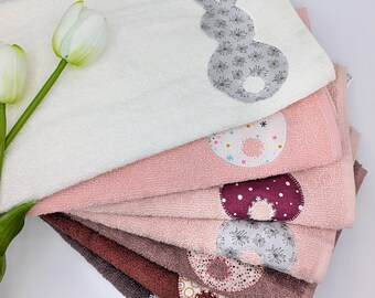 Guest towel with sewn-on appliqués