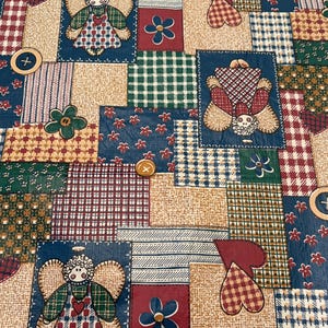 May include: A fabric featuring a patchwork design with rectangular blocks in shades of blue, red, green, and tan. The pattern includes illustrations of angels, hearts, and flowers, interspersed with circular button motifs in a grid-like layout.