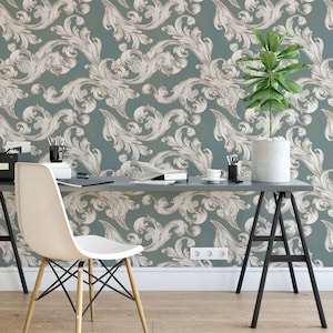 May include: A home office with a teal and white patterned wallpaper, a white desk chair, a gray desk, a potted plant, and a gray and black laptop on the desk.