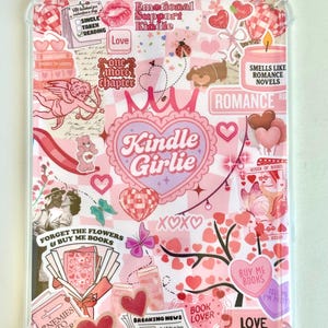 May include: A clear Kindle case with a pink and white collage design. The design includes hearts, butterflies, and text such as "Kindle Girlie", "Romance Novels", and "Buy Me Books". The case is decorated with stickers and illustrations.