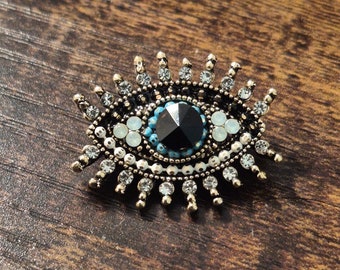 Gorgeous evil eye style rhinestone / gemstone pin/brooch