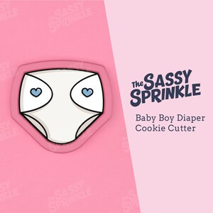 Peut inclure: Emporte-pièce en forme de couche pour bébé, de couleur rose, avec deux cœurs bleus pour les yeux. L'emporte-pièce est intitulé "The Sassy Sprinkle Baby Boy Diaper Cookie Cutter."