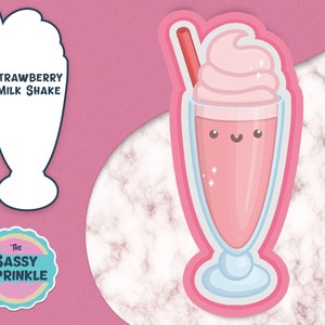 May include: A pink strawberry milkshake with a cute cartoon face and a red straw. The milkshake is in a clear glass with a blue base and is surrounded by a pink outline. The text "Strawberry Milkshake" is written in blue on a white background.