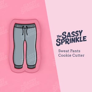 May include: A grey sweatpants cookie cutter with the text "The Sassy Sprinkle" and "Sweat Pants Cookie Cutter" in black.