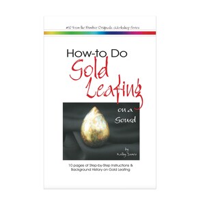 May include: Book cover with the title "How-to Do Gold Leafing on a Gourd" by Kally James. The cover features a gold-leafed gourd in the shape of a teardrop.