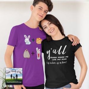 May include: Two people wearing graphic t-shirts. One is purple with cartoon images of a bunny, pancakes, a cat, and a milkshake. The other is black with the text "y'all gonna make me lose my mind" in white script.