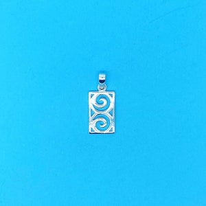 May include: Silver pendant with a rectangular design featuring two stylised swirls.