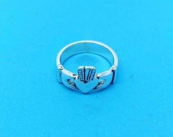 May include: A silver Celtic knot ring with a heart-shaped design. The ring is a traditional Irish symbol of love and friendship.