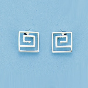 May include: A pair of silver-coloured square stud earrings. Each earring features a Greek key design within a square frame. The earrings are set against a light blue background.