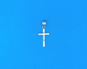 May include: A silver cross pendant with a simple design.