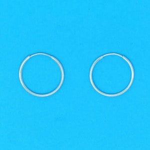 May include: A pair of silver hoop earrings. The earrings are simple and classic, and they would make a great gift for any occasion.