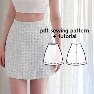 May include: A light blue tweed mini skirt. The skirt has a textured appearance and a classic A-line shape. The image also includes a diagram of the skirt pattern and the text "pdf sewing pattern + tutorial".