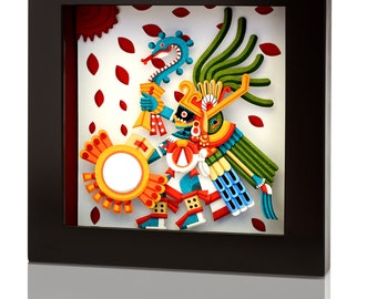 May include: A framed paper art piece depicting a colorful, multi-layered, 3D sculpture of a mythical creature with a feathered headdress, holding a drum and a snake. The background is white with red leaf shapes.