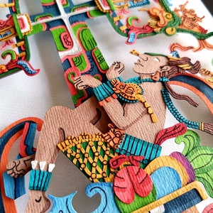 May include: A paper cut-out art piece depicting a figure sitting on a colorful, layered structure. The figure is made of brown paper and has a blue and green patterned skirt. The structure is made of various colors of paper, including red, green, blue, and yellow.