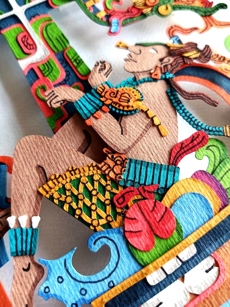 May include: A colorful paper mache sculpture of a figure with a blue and green patterned skirt, a red and green patterned top, and a blue and green patterned headdress. The figure is sitting on a colorful platform with a green, red, and blue design.