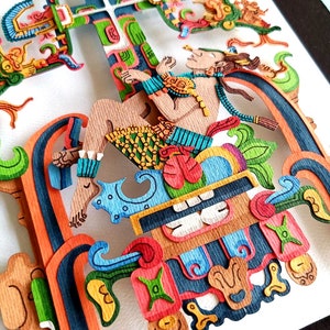 May include: A colorful paper cut-out art piece depicting a figure sitting on a throne with a cross behind them. The figure is adorned with intricate details and vibrant colors, including blue, green, red, yellow, and orange.
