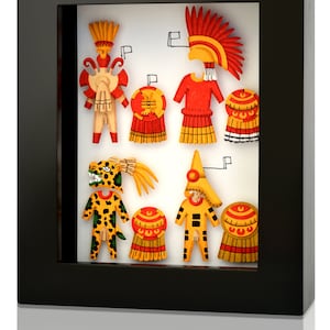 May include: A framed artwork featuring colourful paper cutouts of figures wearing traditional Mexican costumes. The figures are arranged in a row and include a jaguar, a warrior, and a dancer. The artwork is set against a white background.