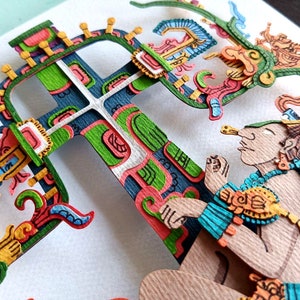 May include: A colorful paper cut-out art piece depicting a figure with a headdress and a large, intricate cross-shaped structure. The figure is holding a small object in its hand. The artwork is made of paper and is painted in various colors, including green, blue, yellow, and red.