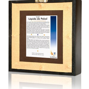 May include: A framed print of a stone inscription in Spanish, titled "L&aacute;pida de Pakal." The inscription describes the tomb of Pakal, a Mayan ruler, and the significance of his death. The print is framed in a dark wood frame with a gold mat.