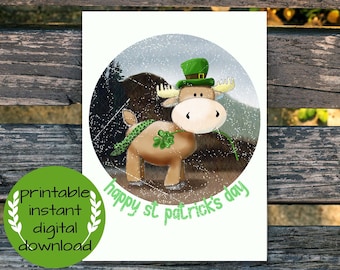 May include: A digital printable card featuring a cartoon moose wearing a green hat with a shamrock and holding a shamrock stem. The card has a white background with a green circle around the moose and the text "happy st patrick's day".