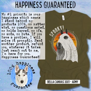 May include: A green t-shirt with a white ghost horse wearing a ghost sheet with the text "Spooky!" printed on the front. The shirt has a blue and white circle with a husky dog and the text "100% happiness guarantee" printed on the back. The shirt is made by Bella Canvas and is a 3001 - Army color.