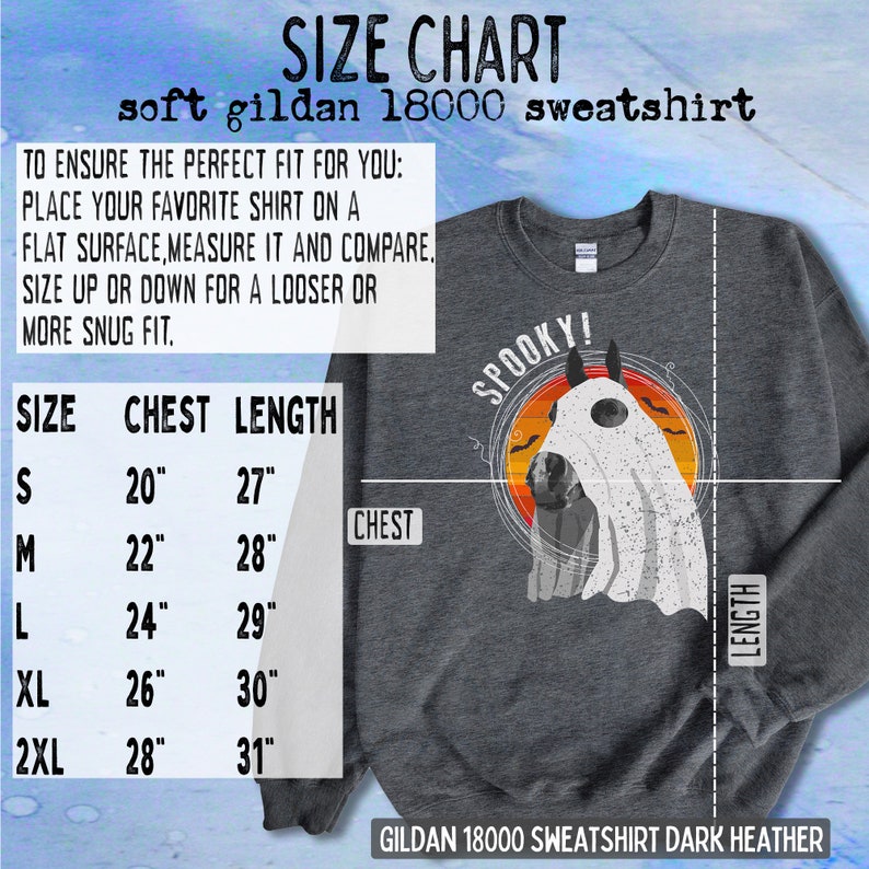 May include: Size chart for a dark heather grey Gildan 18000 sweatshirt with a graphic of a ghost wearing a spooky hat. The chart shows chest and length measurements in inches for sizes S, M, L, XL, and 2XL.