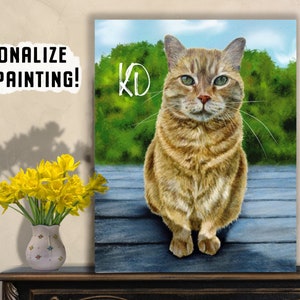 May include: A watercolour painting of a tabby cat sitting on a wooden deck. The cat has green eyes and is looking directly at the viewer. The background is a blurred image of green foliage and a blue sky. The painting is signed "KD" in the top left corner.