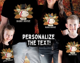 May include: Black t-shirts with a moose design, each labeled with a family member's title: Daddy, Mama, Big, and Little Moose. The moose has a turkey-like appearance with a hat and feather accents. The text "PERSONALIZE THE TEXT!" is displayed.