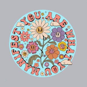 May include: A blue and white circle with the text "You Are What You Manifest" in a retro font. The circle is filled with colorful flowers and smiling faces.