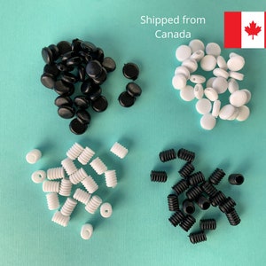 May include: Assortment of black and white silicone ear savers for face masks. There are three different styles of ear savers: round, flat, and spiral.
