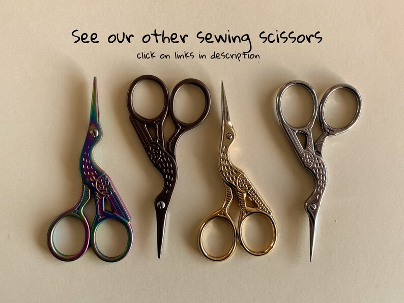 May include: Four pairs of decorative sewing scissors with bird-shaped handles. The scissors are in different colors: iridescent, black, gold, and silver.
