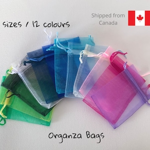 May include: Assortment of colourful organza bags in various sizes. The bags are made of sheer fabric and have a drawstring closure. The text "4 sizes / 12 colours" and "Organza Bags" is visible in the image.