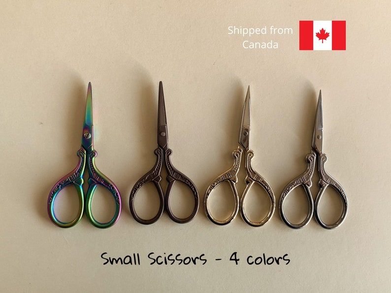 May include: Four pairs of small decorative scissors in different colors: rainbow, black, gold, and silver.  "Small Scissors - 4 colors" is written below the scissors.