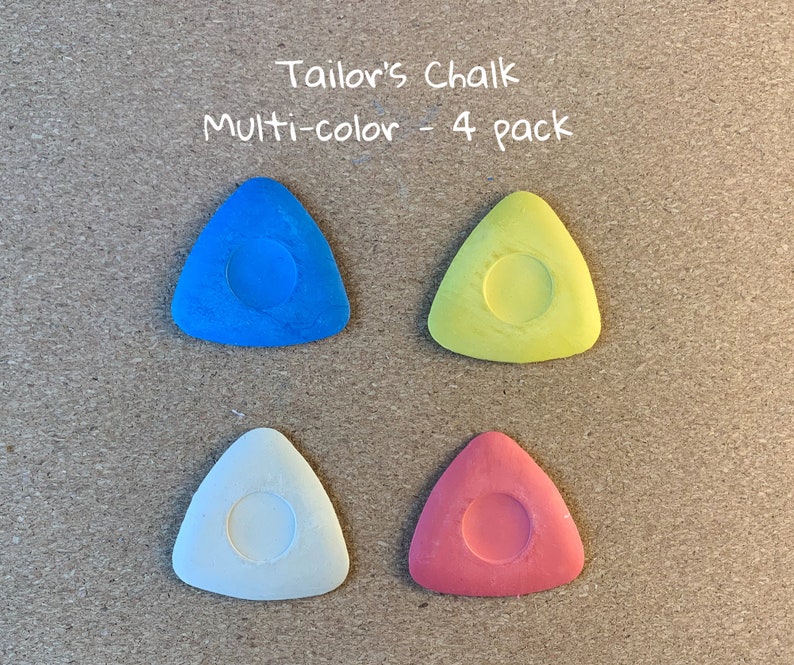 May include: Four triangular tailor's chalk pieces in blue, yellow, white, and red. The chalk is in a 4 pack and labeled "Tailor's Chalk Multi-color - 4 pack".
