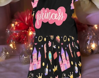 May include: A black and pink princess dress with a pink "princess" word on the bodice and a black and white print of castles, crowns, and combs on the skirt.